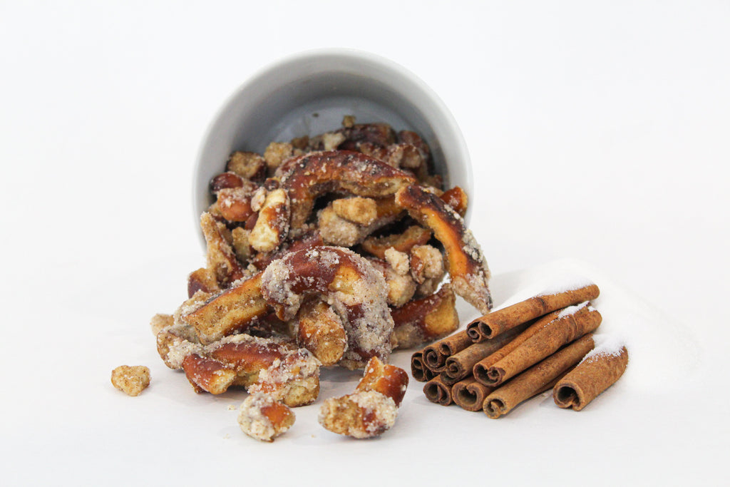 Sugar + Spice Pretzel Bites with cinnamon sticks and sugar to show the flavors
